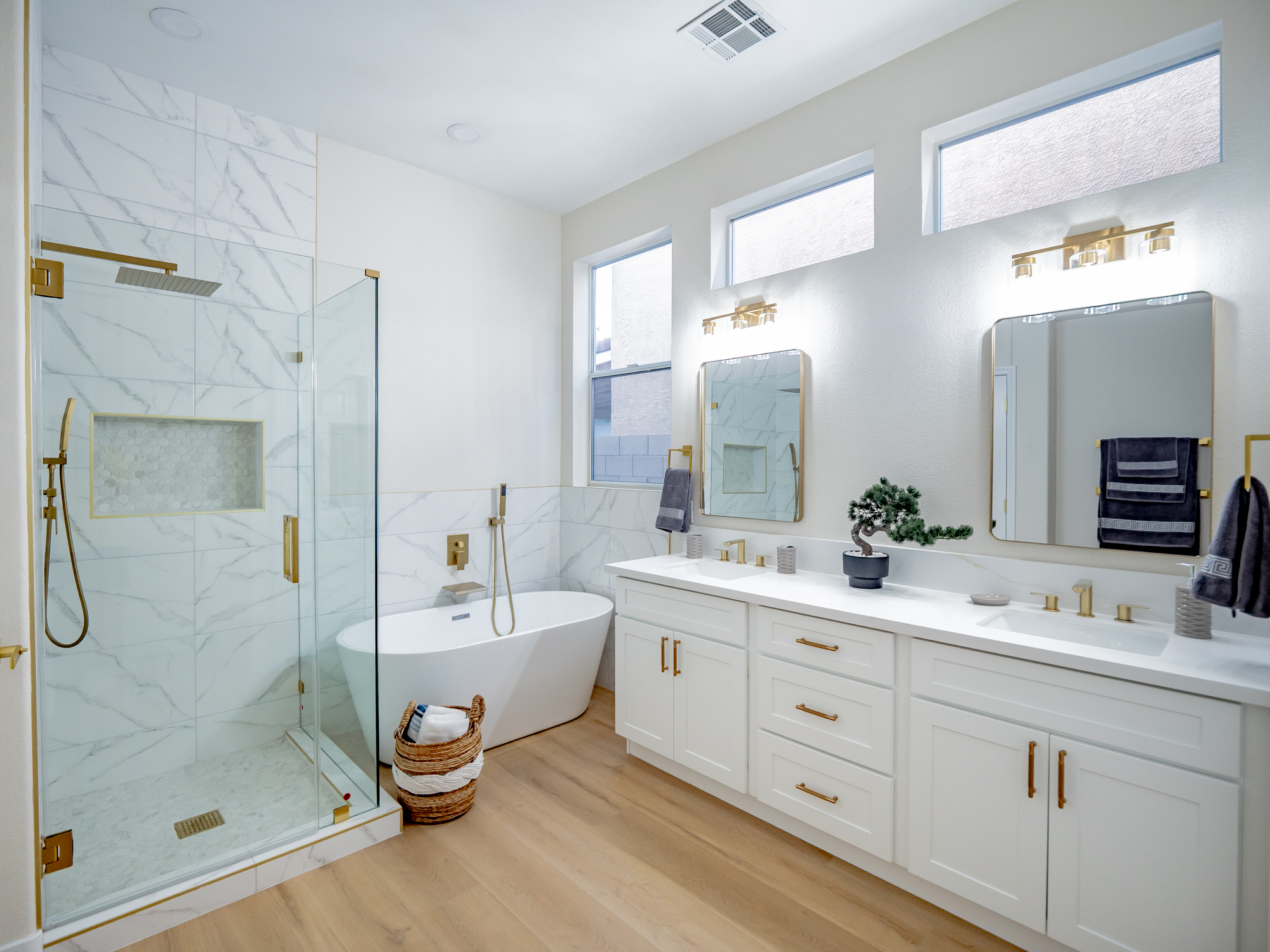 Master bathroom remodel with a freestanding tub, marble tile, and glass shower by Nevada Pro Construction